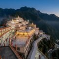 Vaishno Devi Navratri 2026 — flower-decorated Bhawan complex lit up on the Trikuta hills at dusk