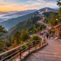 Vaishno Devi yatra tips - dawn view of pilgrims on the railed Trikuta hills track toward the Bhawan