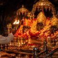 Evening aarti with priest waving the lamp before the Trishakti Pindis