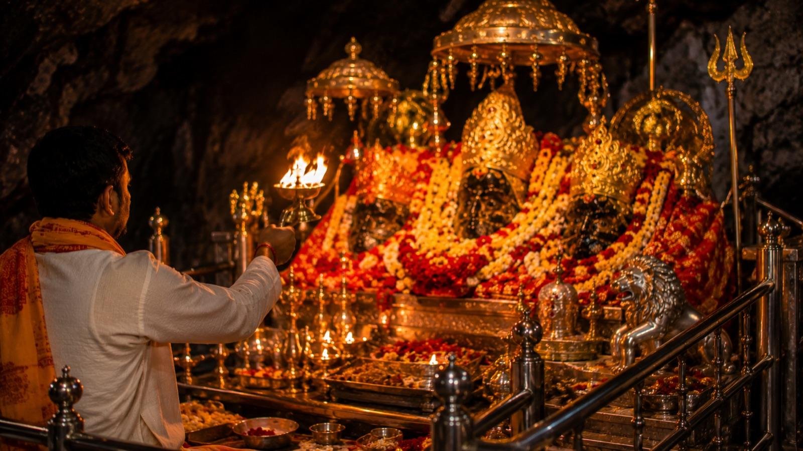 Evening aarti with priest waving the lamp before the Trishakti Pindis during Navratri