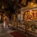 Inside the Vaishno Devi cave shrine showing silver-clad walkway and Pindis