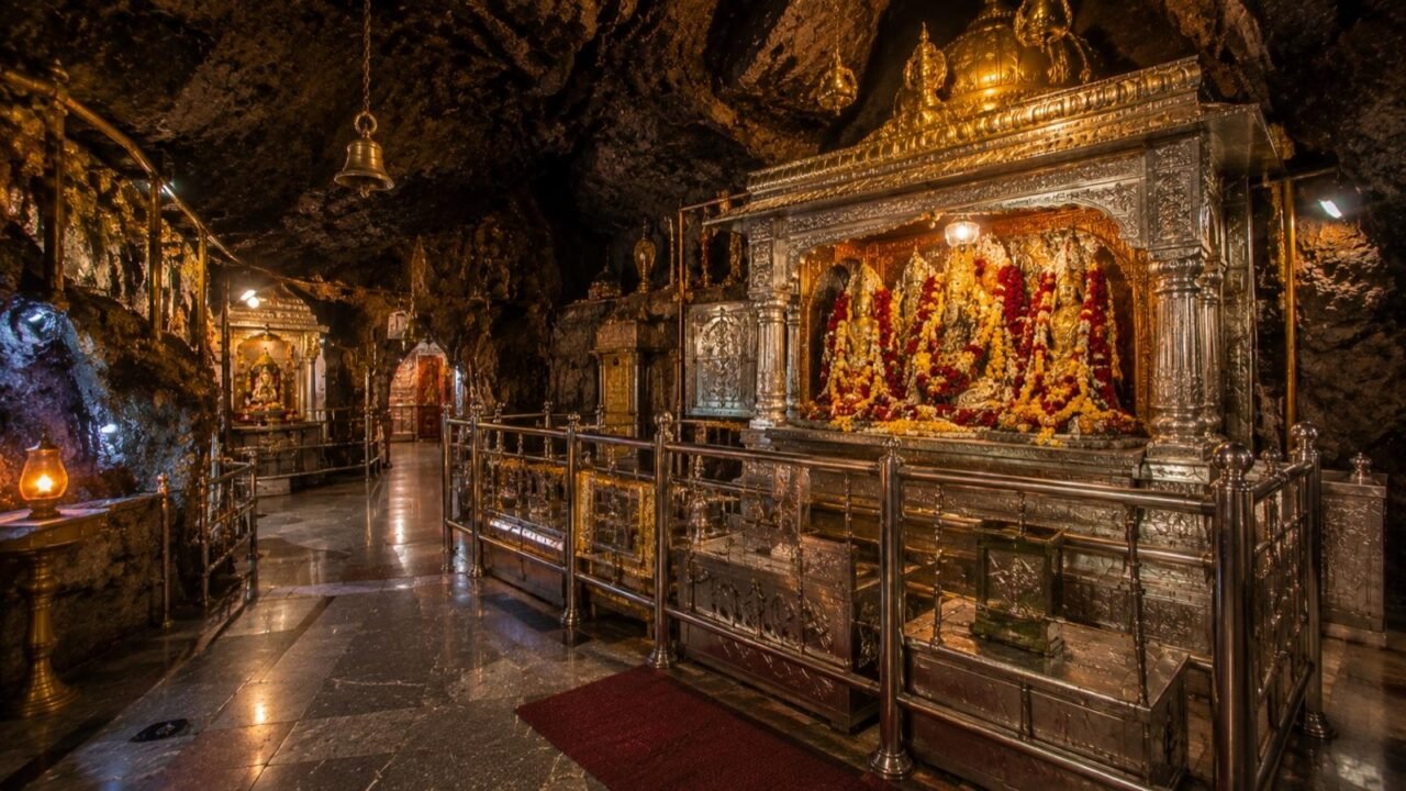 Inside the Vaishno Devi cave shrine showing silver-clad walkway and Pindis