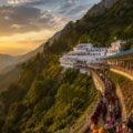 Pilgrims walking the Vaishno Devi yatra track towards Bhawan at sunrise