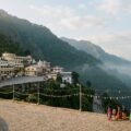Vaishno Devi Pindi darshan: Holy Cave Bhawan on the forested Trikuta hills with pilgrims on the path